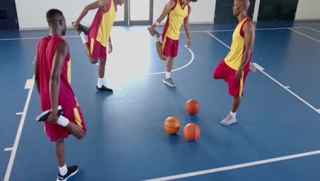 Diverse-basketball-players-practice-in-an-indoor-court