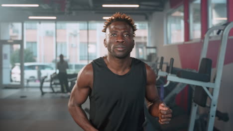 man running on a treadmill in a gym