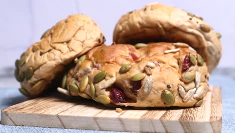 close-up of homemade seed and cranberry buns on a wooden board