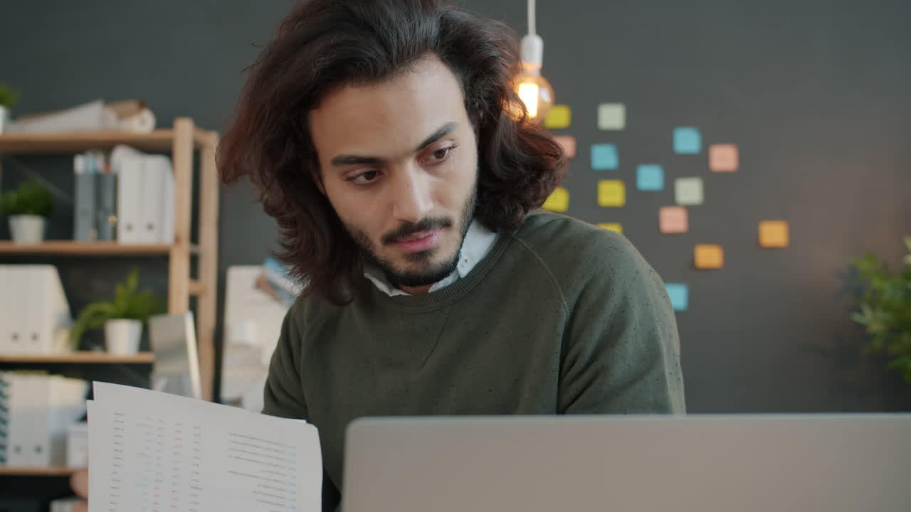 Businessman Reviewing Documents at Workplace