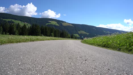 couple woman and man on electric eco bike cycling italy dolomites alps