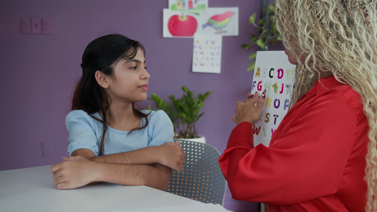 Speech Therapist Having Individual Lesson with Teenage Girl at Classroom