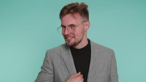 man pointing to camera and looking with playful happy expression making choice showing direction