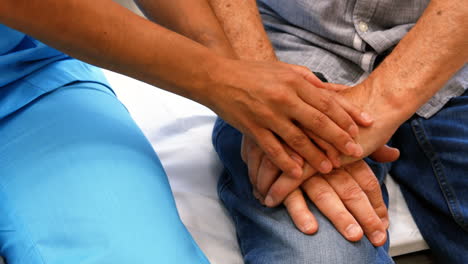 Close-up-of-female-doctor-consoling-a-patient