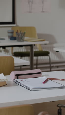 classroom scene with desk and school supplies