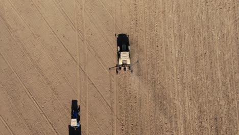 Farm-Tractor-Ploughing-Soil-On-vast-Field-During-Summer-In-Kyiv,-Ukraine