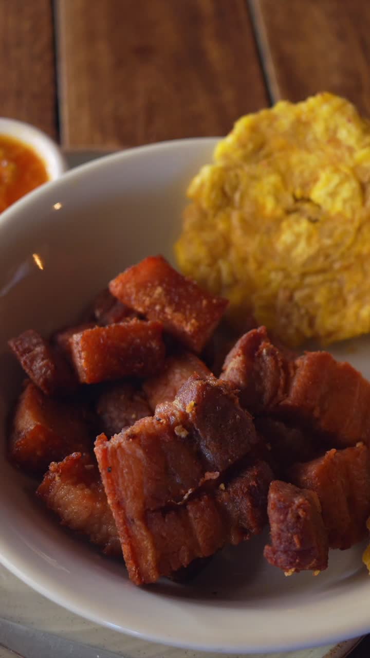 Colombian Chicharron Fried Pork with Fried Plantain Portion. Close Up. Vertical