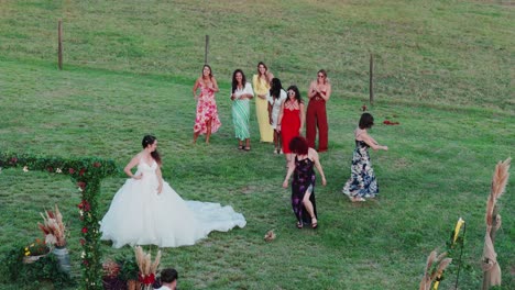 aerial shot of a bride throwing her flowers towards her bridesmaids but failing