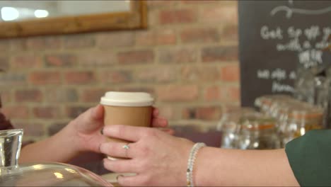 Handing-Coffee-to-Customer-in-Cafe-01