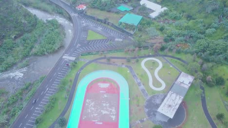 panoramic aerial tilt down over outdoor speed roller skating ring in faial or fayal