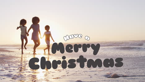 children running on beach, have merry christmas text over sunset background