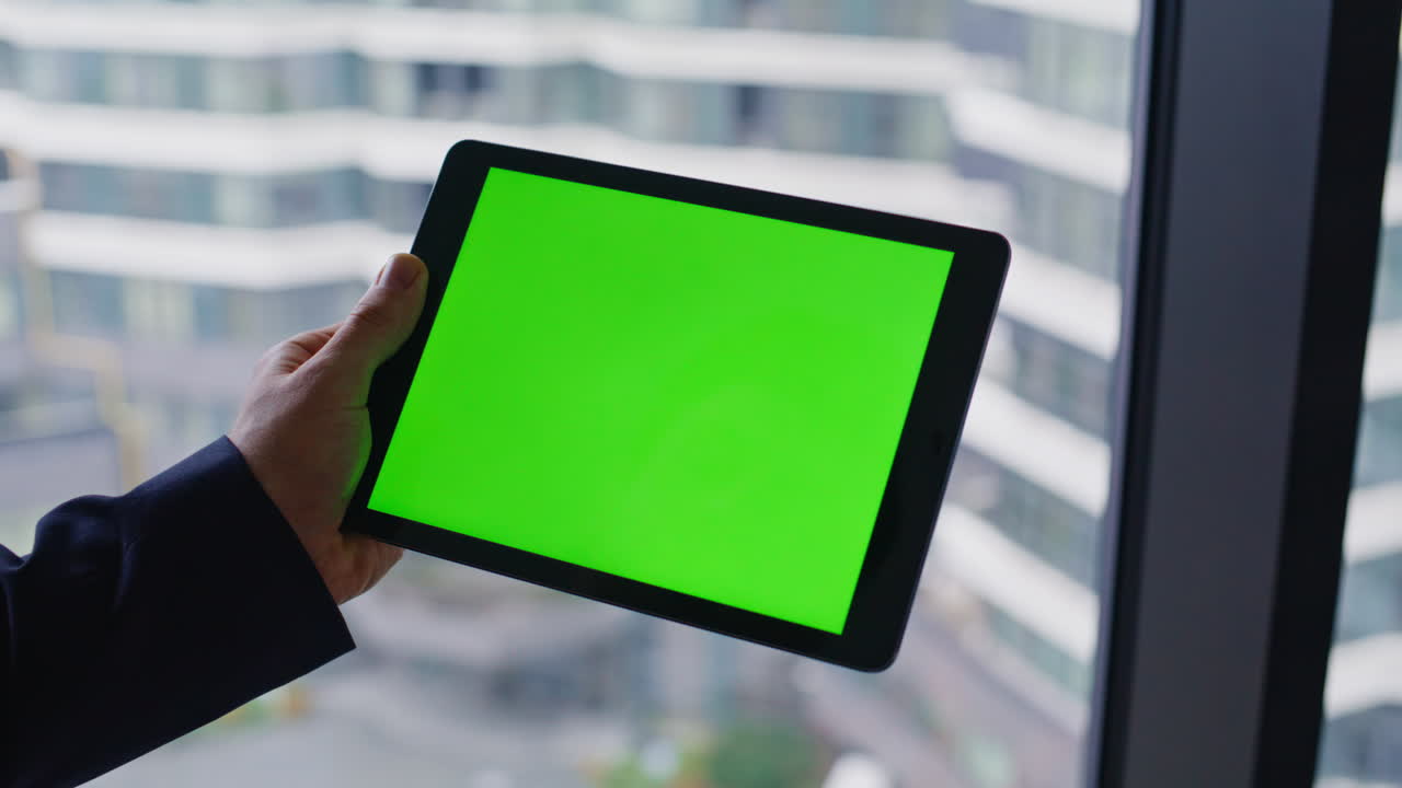 Businessman Using Tablet with Green Screen in Modern Office