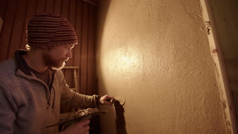 wide, backlit, a handsome professional plasterer using a japanese trowel