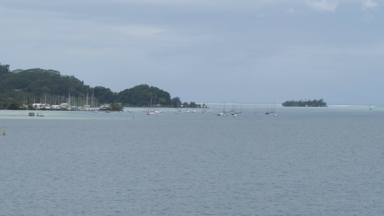 Yachts and sail boats anchored in the bay near Uturoa, Raiatea, French Polynesia.
