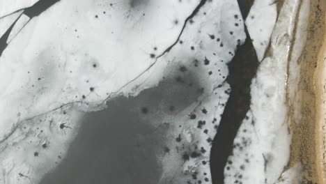 a track in bird's eye of the thinning ice shelf over dune harbor lake's surface