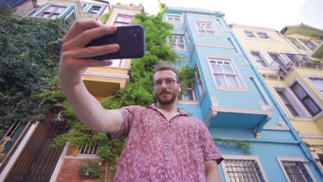 young man taking selfie with his phone.