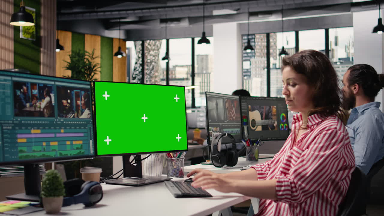 Green screen with video editing montage on computer used by filmmaker