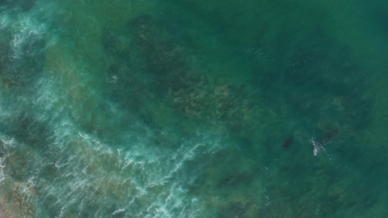 Shoreline ocean waves shake the sand