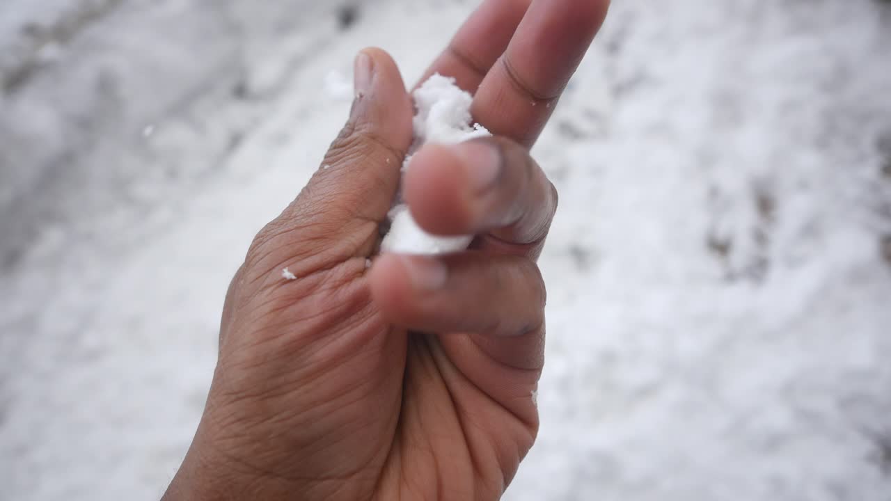 Hand playing with snow