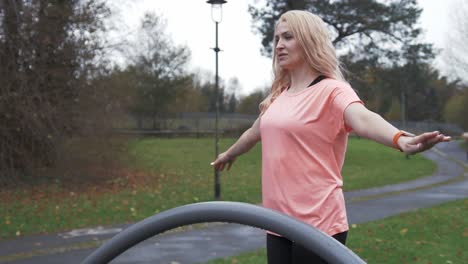 athletic woman performs mobility balancing exercise outdoors