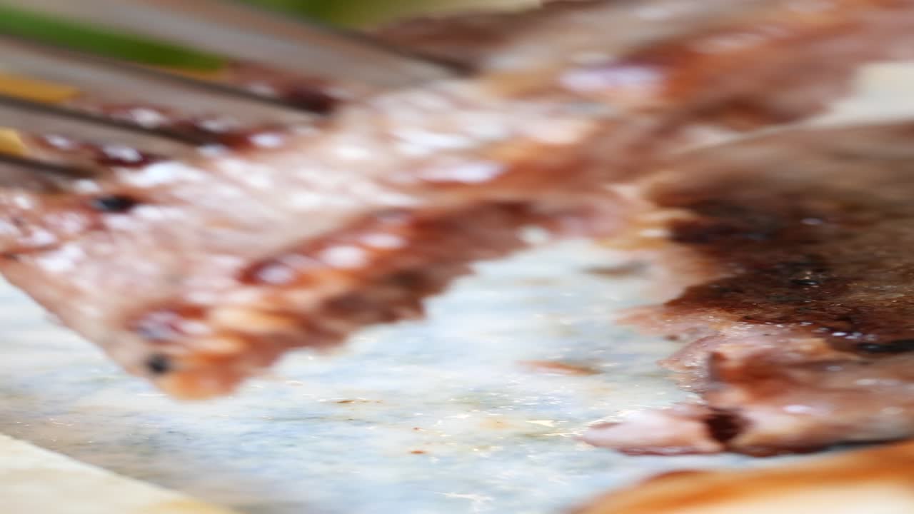 Close-up view of a juicy grilled steak being cut with a fork