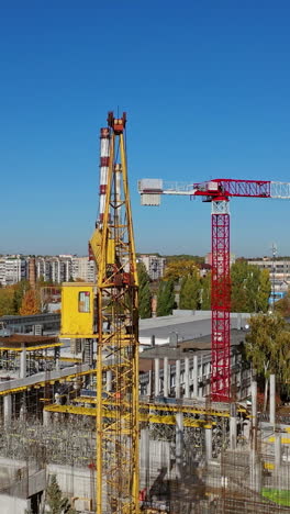 construction site with a bird's eye in a megacity. video shooting with drone. new office in a new residential complex. aerial view. vertical video