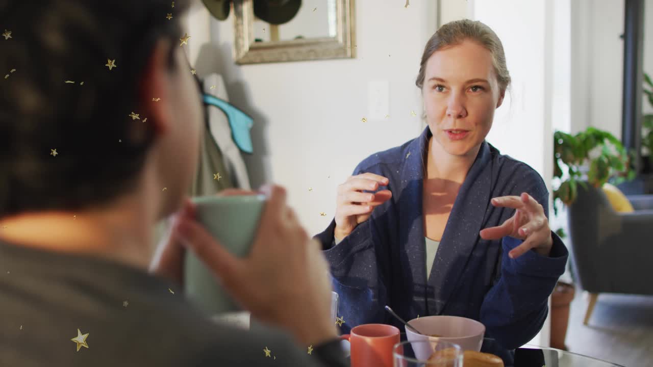Speaker starting explanation with gestures at dining table showing animated educational scale bars