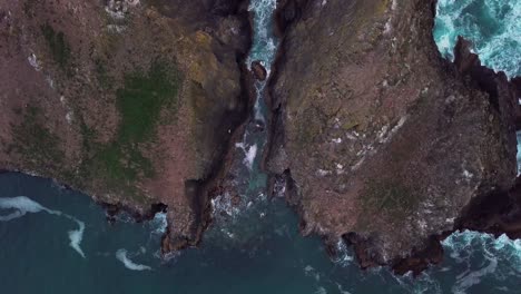 Birds-eye-view-of-a-crevice-separating-two-small-rocky-islands