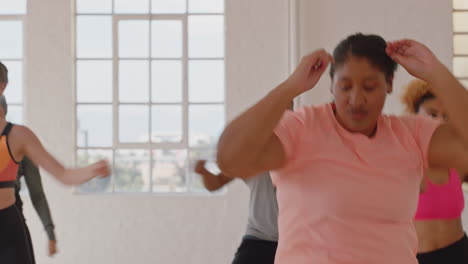 happy overweight woman dancing group of healthy people enjoying workout practicing choreography moves with dance instructor having fun in fitness studio