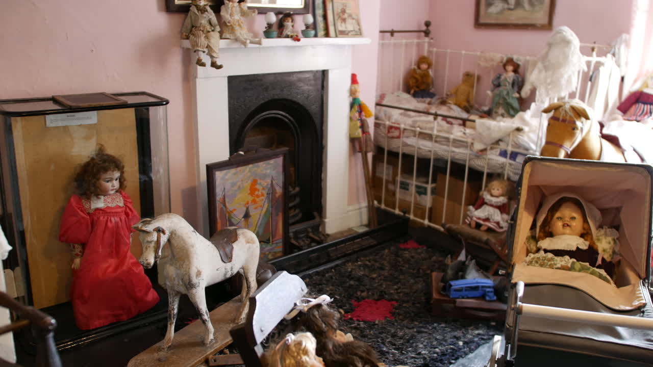 Victorian nursery room with antique dolls, vintage toys, and classic creepy baby carriage, ideal for historical settings. Cozy, old-time child's room with fireplace