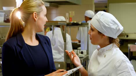 female manager and female chefs talking to each other 4k