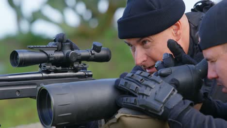 Side-view-of-caucasian-military-soldiers-looking-through-binoculars-and-riflescope-at-training-4k