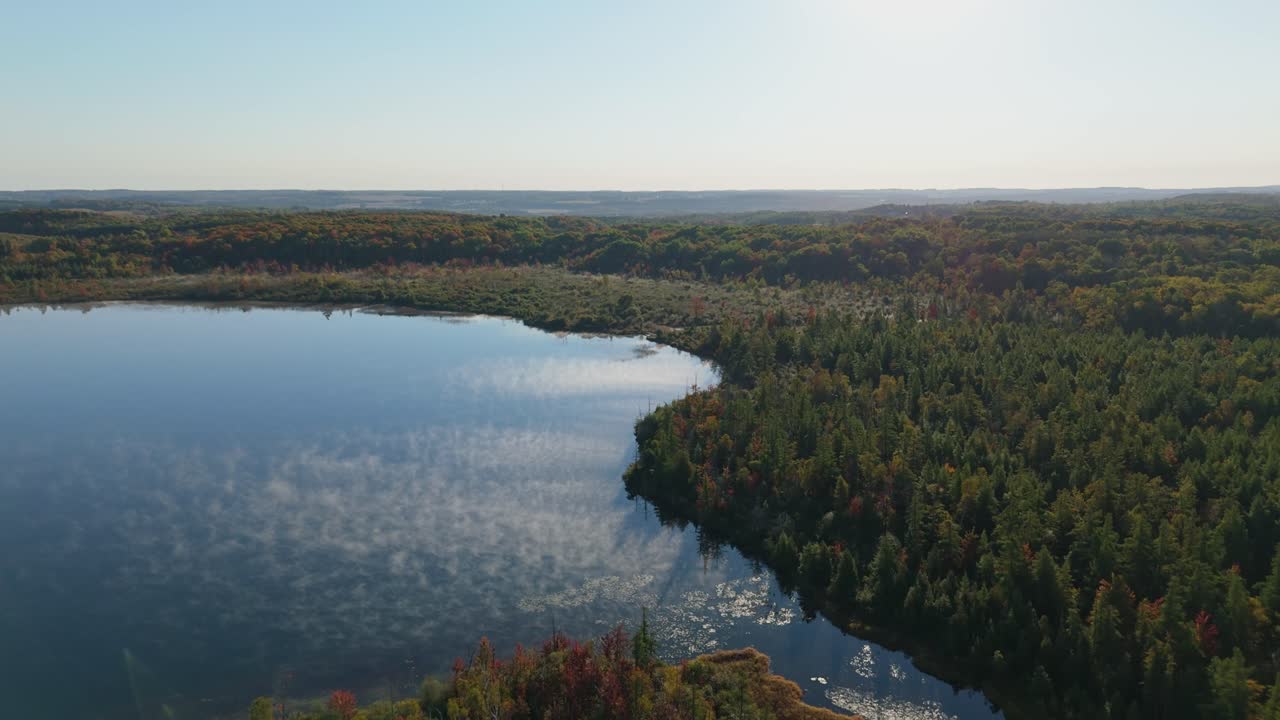 Serene aerial view of Caledon Lake, surrounded by lush autumn forest