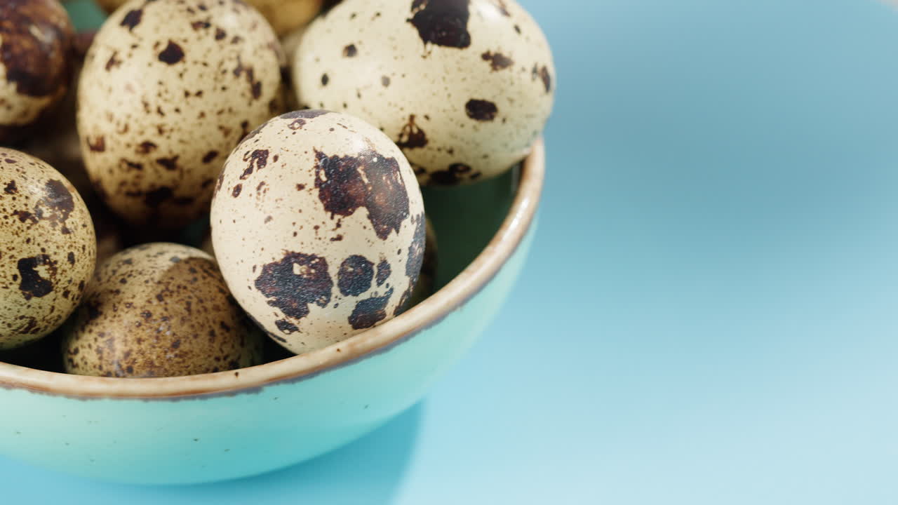 Fresh Quail Eggs in a Blue Bowl with Copy Space