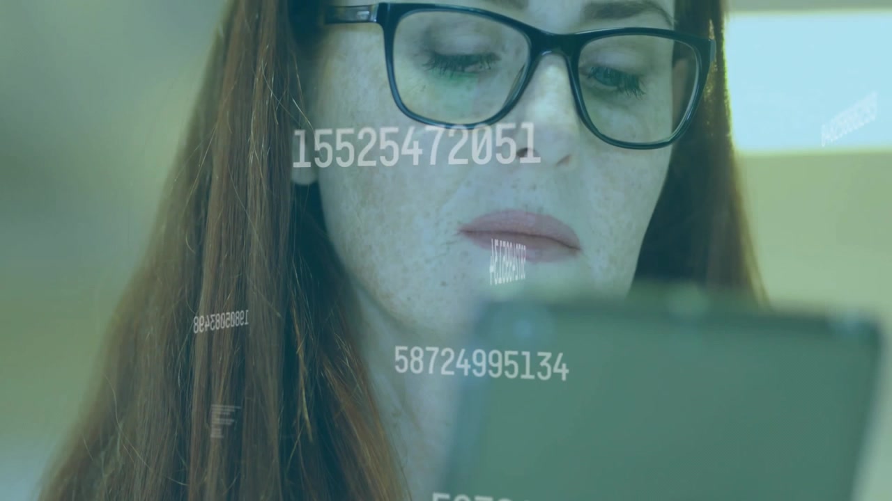Data analyst tapping tablet and reviewing floating numeric streams for analytics in tech office