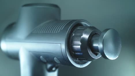 a close up shot of a massage muscle gun, vibrating tool, slow motion full hd video, studio lighting, black plastic head