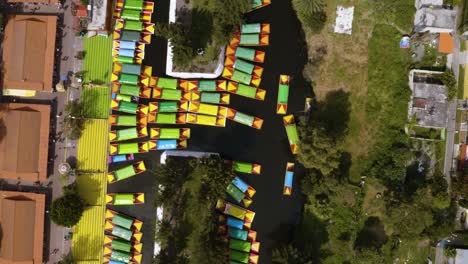 top down birds eye view of xochimilco, green, yellow, and red trajineras