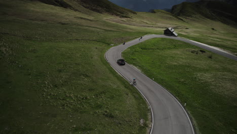 Auto-Fährt-Den-Kurvigen-Giau-Pass-Hinunter,-Vorbei-An-Motorrädern-In-Malerischen-Dolomiten