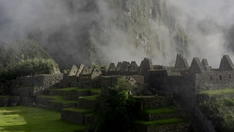 zoom out of machu picchu ruins citadel with huayna pichu mountain in background. wide shot, panorama
