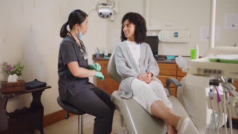 female dentist consulting with a client on oral