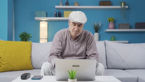 Old-man-using-laptop-with-happy-expression.