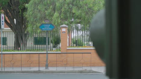 cars driving by luis montoto street sign in seville, slow motion