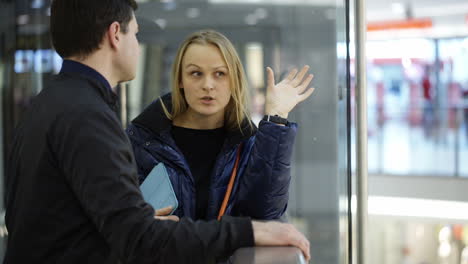 man and woman discussing something in trade center