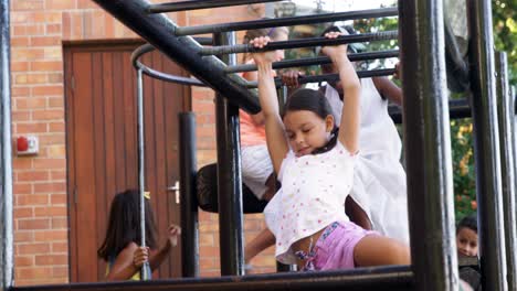 Schoolgirl-hanging-on-monkey-rack