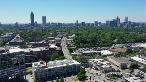 traffic on main road in suburb area with forest and skyline of atlanta city