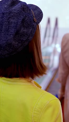 teenage girl in a yellow jacket and denim cap