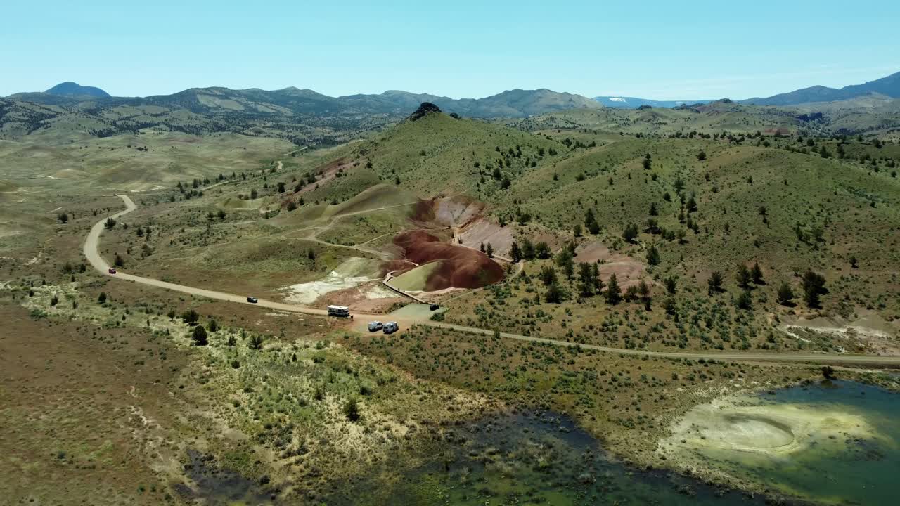 US, Oregon, Prineville, Painted Hills, 2025-05-05 - Drone view of the Painted Cove Trail in the John Day Fossil Beds National Monument in central Oregon. Red and Pink dirts with grass