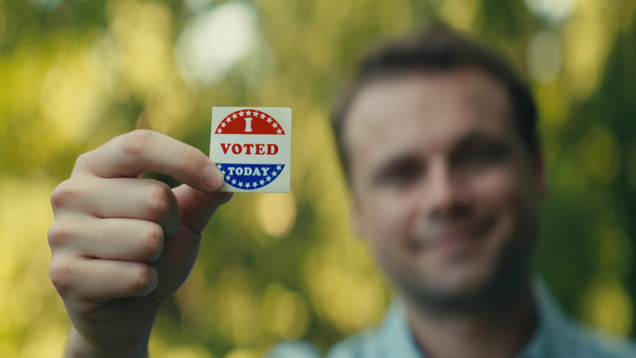 Man Holding 'I Voted' Sticker