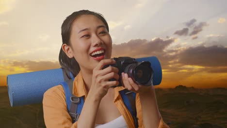 woman taking photos of sunset mountains