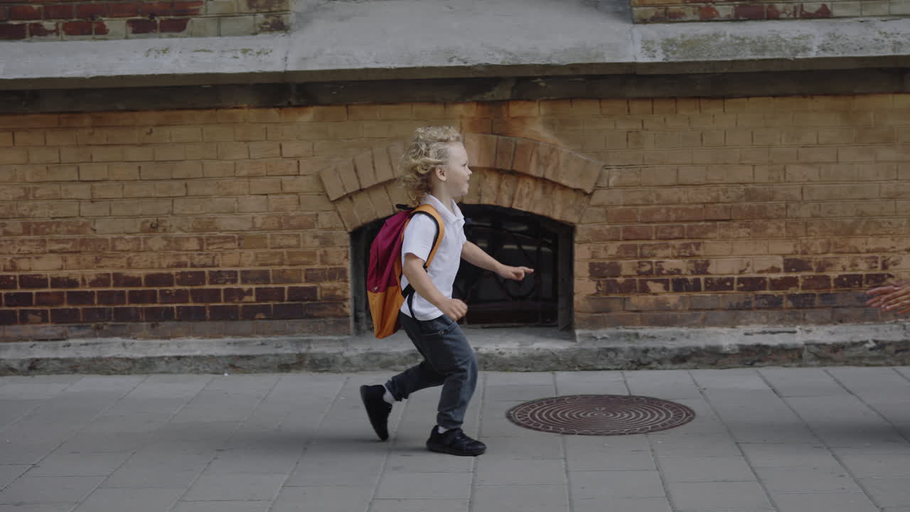 A child running to school and a mother hugging her child